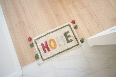 a rug with the word home written on it is on the floor in a hallway