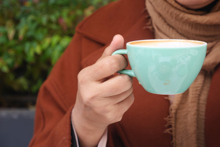 women holding a coffee cup
