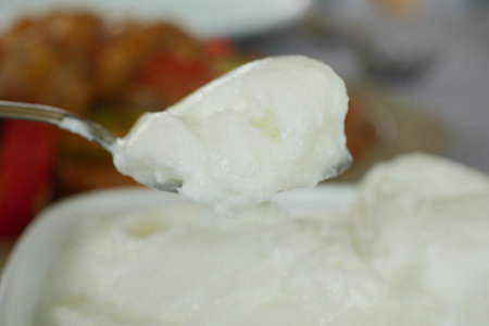spoon pick fresh yogurt closeupの写真素材
