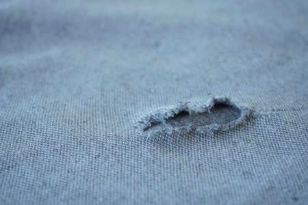 hole in the clothes. Close-up.