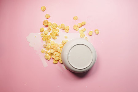 Spilled breakfast cereal on a pink backgroundの写真素材