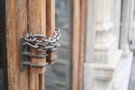 Closed old rusty lock on a wooden doorの写真素材