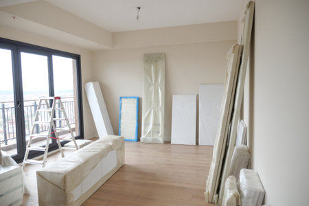 An empty room with hardwood flooring and wrapped in plastic.の写真素材