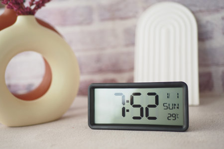 Start your day right by placing a digital alarm clock on a table to wake up in the morning