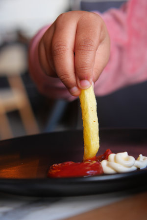 child eating french fries close upの写真素材