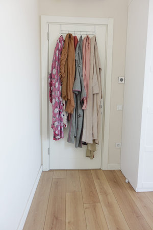 shirts hung on clothes hangers as a decorative fixture on the door ,の写真素材
