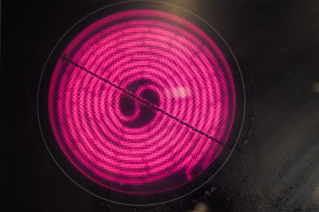 The Electric Stove Coil Element emits a warm glow while cooking, essential for cookware
