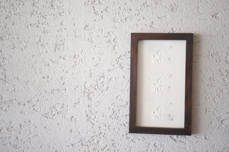 Minimalist framed artwork on textured wall, adding aesthetic and artistic touchの写真素材