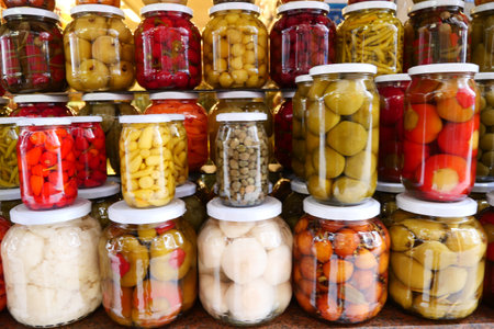Canned fruits and vegetables in glass jarsの写真素材
