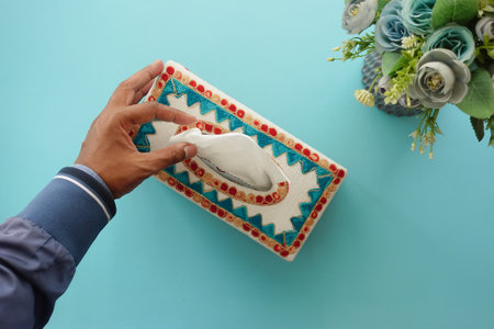 hand pull out a piece of tissue from tissue paper boxの写真素材