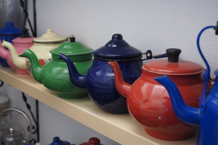 A Beautiful Collection of Colorful and Unique Teapots Displayed on a Decorative Shelfの写真素材