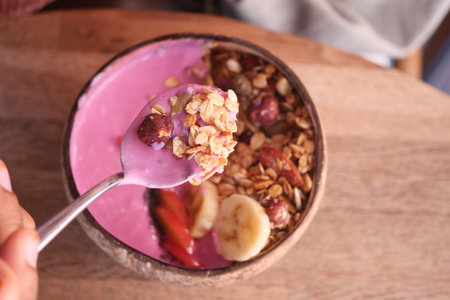Indulge in a nutritious Smoothie Bowl with a variety of fresh fruits and nuts for a healthful boostの写真素材