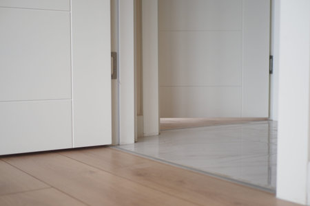 Explore the modern and stylish interior transition between luxurious wood and elegant tile floorsの写真素材