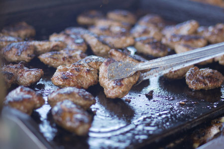 Indulge in Sizzling Grilled Meat Cooked Perfectly on a Flat Top Grill for Your Enjoyment