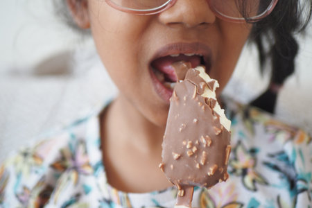 child happily eating an ice cream bar, exuding joy and enjoyment
