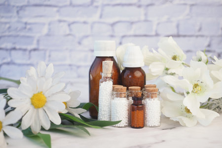 Homeopathic pills containers on a tableの写真素材