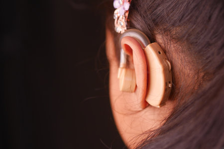 Hearing aid concept, little girl with hearing problems.の写真素材