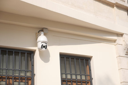 CCTV security camera operating on a house building