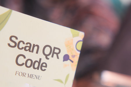 woman hand using the smart phone to scan the qr code to select food menu in the restaurant