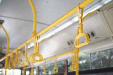 A row of yellow handle on a busの写真素材