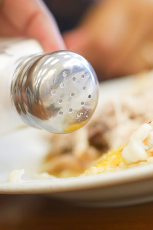 Salt falls from a salt shakerの写真素材