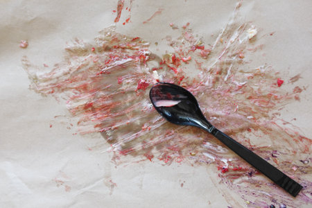 A Messy Table Setting Featuring a Spoon Surrounded by Colorful Stains in Abstract Artの写真素材