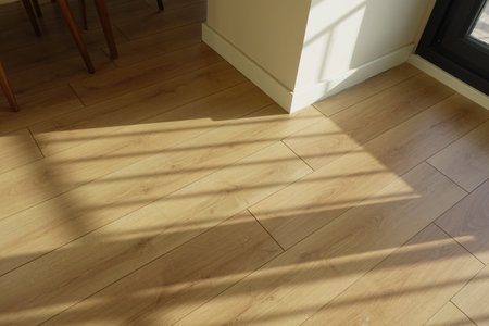 The interplay of natural light and shadows beautifully enhances the appearance of a wooden floorの写真素材
