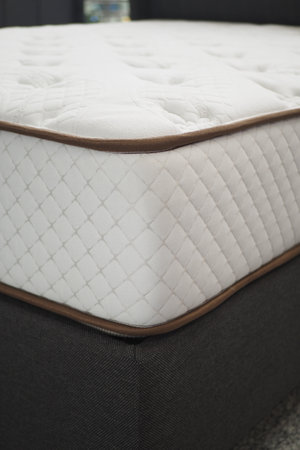 Detailed closeup view of a white mattress showcasing knitted design, offering comfort and styleの写真素材