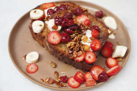 Deliciously Topped Banana Bread Made with Fresh Berries, Granola, and a Touch of Sweetnessの写真素材
