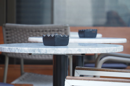 An Elegant Outdoor Dining Space Features a Beautiful Marble Table Accompanied by Stylish Chairsの写真素材