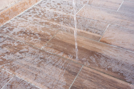 Water is splashing on stunning tiles designed to resemble beautiful wooden surfacesの写真素材