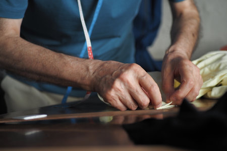 An Intimate CloseUp Idea of Hands Skillfully Sewing Fabric with Great Precision and Careの写真素材