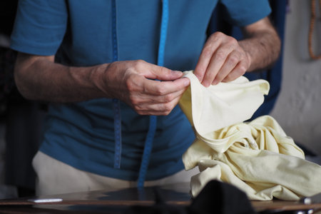 The Hands of a Highly Skilled Tailor are Carefully Sewing Fabric with Great Precisionの写真素材