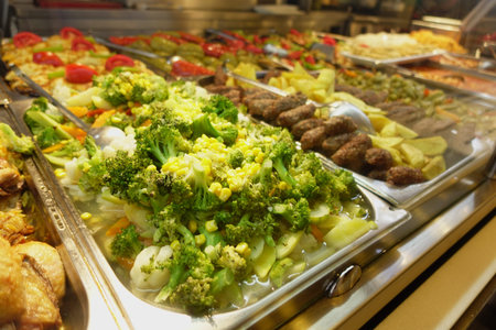 A Colorful Buffet Selection Featuring an Exquisite Array of Fresh Vegetables and Grilled Meatsの写真素材