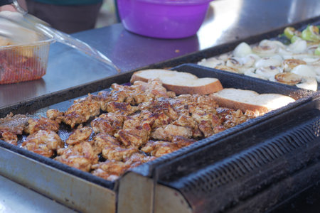 Enjoy the delectable experience of Grilled Meat and Bread being prepared on a Street Vendor Grill