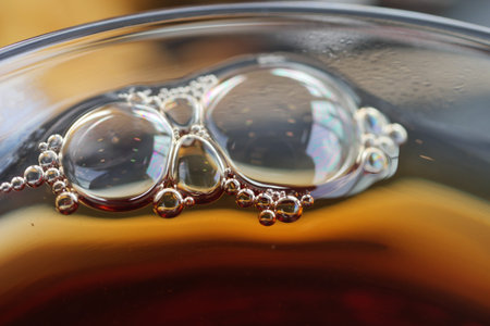 A CloseUp Image Capturing the Intriguing Bubbles Forming in a Dark Liquid Background