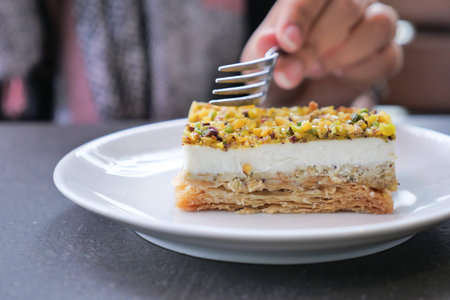 A Delicious Layered Dessert Artistically Arranged with Pistachios Presented on a Plate