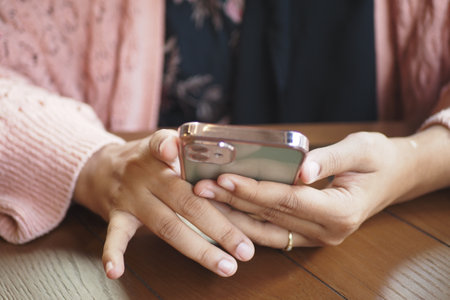 women hand holding smart phone sitting on cafeの写真素材