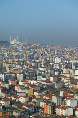 An aerial view of an urban landscape shows a mosque, blending modern architecture with cultureの写真素材