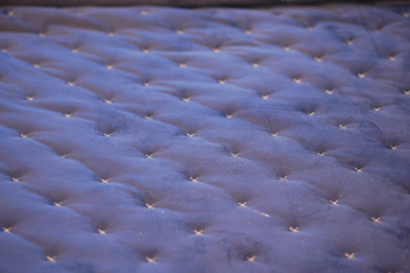 An Intimate CloseUp of the Surface of a Plush Mattress Featuring Beautiful Button Tuftsの写真素材