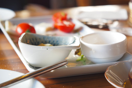 empty bowls with a spoon rests after a delicious, satisfying meal has been enjoyedの写真素材