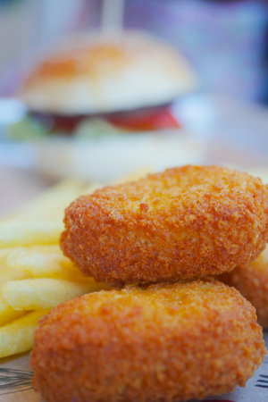 Enjoy tasty Chicken Nuggets with hot, crispy Fries and a savory Burger to satisfyの写真素材