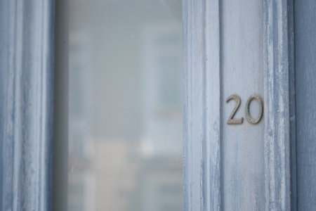 An Elegant Blue Door featuring an ornate Number 20 detail that adds charm and characterの写真素材
