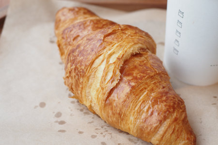 fresh baked croissant on plate with copy spaceの写真素材