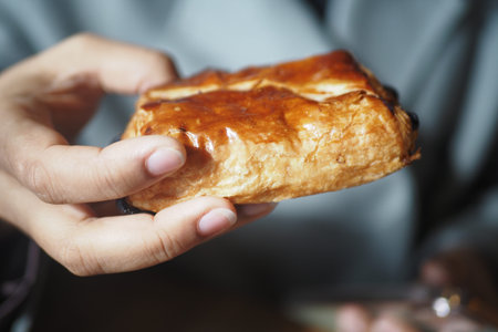 Enjoying a Freshly Baked Pastry Right in My Hand While Savoring Every Delicious Bite