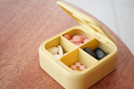 close up of medical pills in a pill box on tableの写真素材