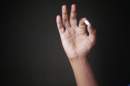Close up of man hand holding pills with copy spaceの写真素材