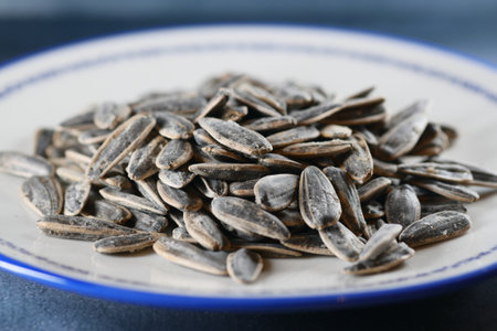 sun flower seeds in a bowl on tableの写真素材