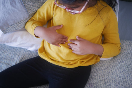 child suffering stomach pain close up.の写真素材