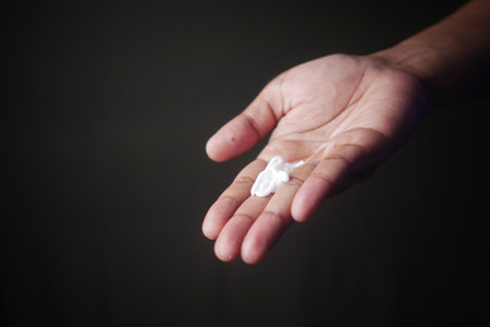 Gently Applying Moisturizer on Skin with a Careful and Considerate Touch to Ensure Comfortの写真素材